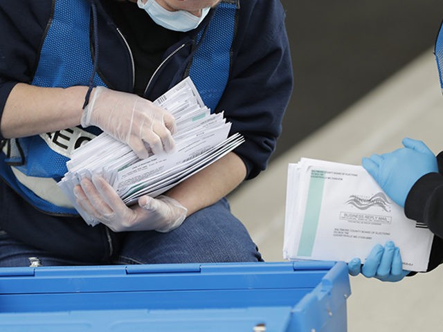 Election workers Jessica Fleming, left, and Amanda White count ballots while collecting them from a drop box outside a voting center during the 7th Congressional District special election, Tuesday, April 28, 2020, in Windsor Mill, Md. The election to fill a seat left open by the death last October of …