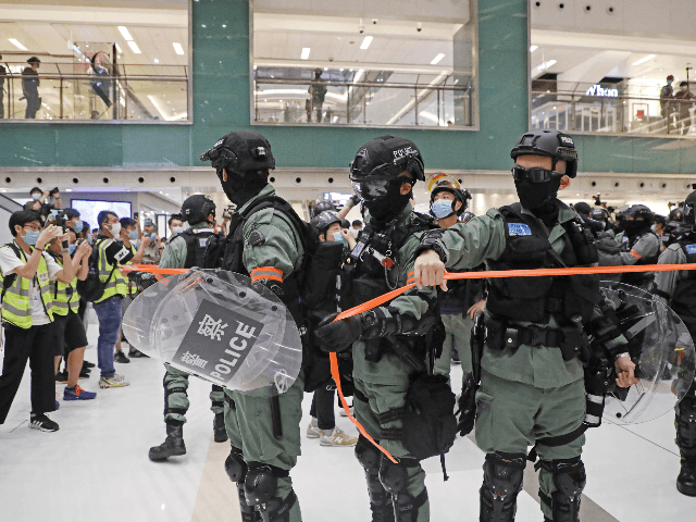Riot police enter the shopping mall to disperse the protesters during the Labor Day in Hon