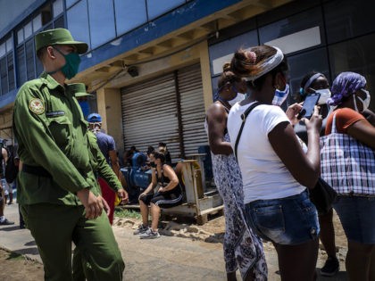 People wearing masks as a precaution against the spread of the new coronavirus talk to eac