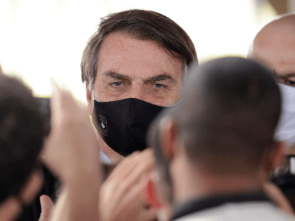 Brazil's President Jair Bolsonaro, wearing a face mask amid the new coronavirus, faces sup