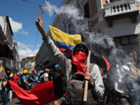 A protester holds a flare during a workers’ unions protest against government reforms to fight the economic and health crisis brought by the COVID-19 pandemic in Quito, Ecuador, Monday, May 25, 2020. Worker unions say the reforms include shortening workdays from 8 to 6 hours, thus lowering pay, and criticize …