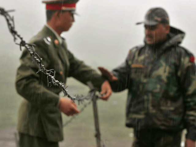 In this July 5, 2006 file photo, a Chinese soldier, left, and an Indian soldier put into p