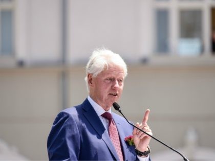 Former U.S President Bill Clinton gestures as he speaks during a ceremony in Pristina, on