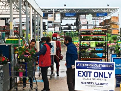 Customers get checked out from the garden center at a Lowe's store in Harrisburg, Pa., Wed