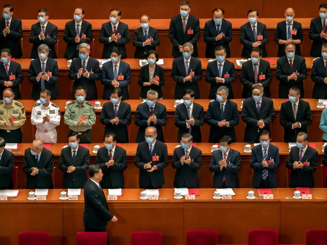Delegates applaud as Chinese President Xi Jinping arrives for the closing session of China's National People's Congress (NPC) in Beijing, Thursday, May 28, 2020. China's ceremonial legislature has endorsed a national security law for Hong Kong that has strained relations with the United States and Britain. (AP Photo/Mark Schiefelbein)