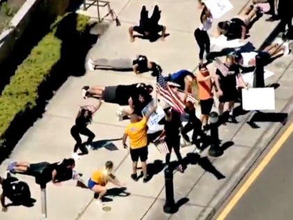 Demonstrators Do Squats and Pushups