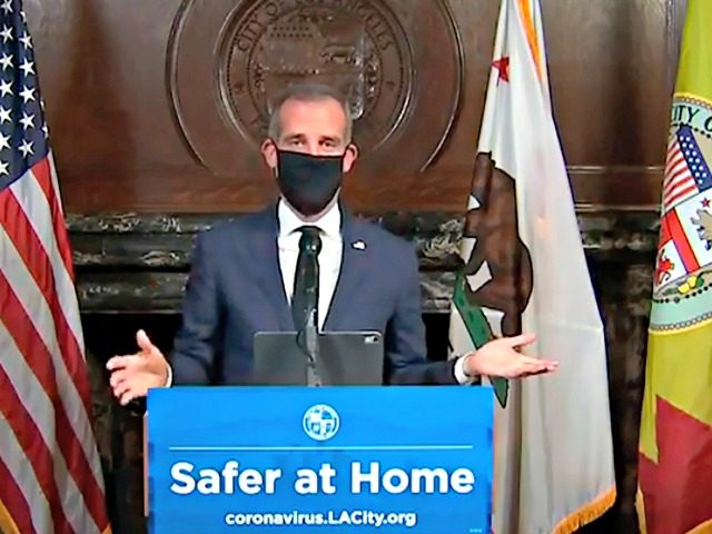 This Wednesday, April 1, 2020 file photo from a live stream video provided by the Office of Mayor Eric Garcetti shows Los Angeles Mayor Garcetti wearing a protective face mask during his daily coronavirus news conference in Los Angeles. Garcetti is currently conducting all briefings and interviews remotely. On Monday, …