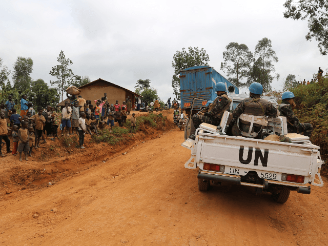 In this photograph taken on March 13, 2020, Moroccan soldiers from the UN mission in DRC (Monusco) ride in a vehicle as they patrol in the violence-torn Djugu territory, Ituri province, eastern DRCongo. - Fresh violences have been registered against civilians in this territory where more than 700 hundreds have …