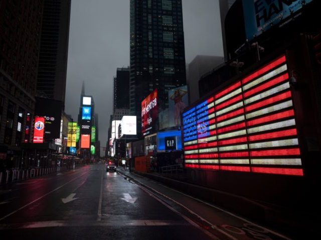 TOPSHOT - The US Flag illuminates a street in Times Square amid the Covid-19 pandemic on April 30, 2020 in New York City. (Photo by Johannes EISELE / AFP) (Photo by JOHANNES EISELE/AFP via Getty Images)