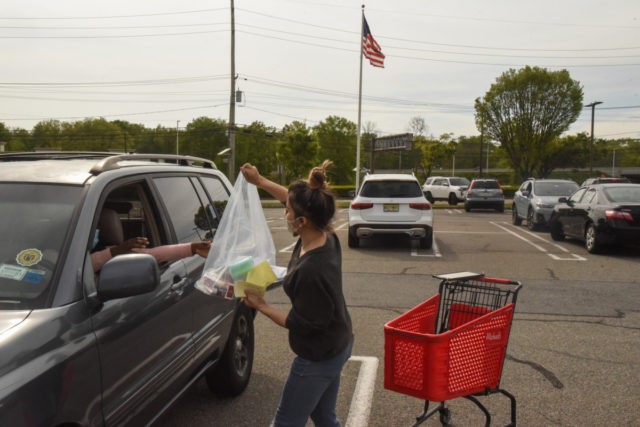 PARAMUS, NJ - MAY 18: An employee of Michaels retail store delivers an order to a customer