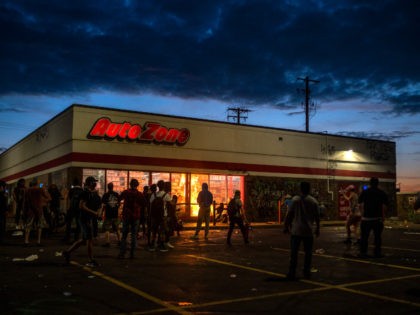 MINNEAPOLIS, MN - MAY 27: A fire burns inside of an Auto Zone store near the 3rd Police Precinct on May 27, 2020 in Minneapolis, Minnesota. Businesses near the station were looted and damaged today as the area has become the site of an ongoing protest after the police killing …