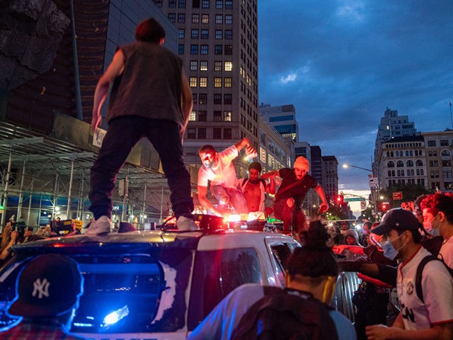 NEW YORK, NEW YORK - MAY 30: Protestors vandalize a police cruiser in Union Square on May