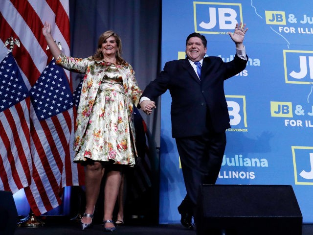 Democratic candidate for governor J.B. Pritzker waves to supporters as he enters the stage with wife M.K. to claim victory in Chicago, Tuesday, Nov. 6, 2018. (AP Photo/Nam Y. Huh)