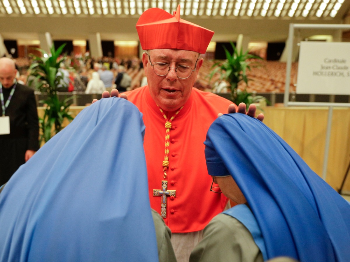 Cardinal Jean-Claude Hollerich greets two nuns prior to meeting relatives and friends after he was elevated to cardinal by Pope Francis, at the Vatican, Saturday, Oct. 5, 2019. Pope Francis has chosen 13 men he admires and whose sympathies align with his to become the Catholic Church's newest cardinals. (AP Photo/Andrew Medichini)