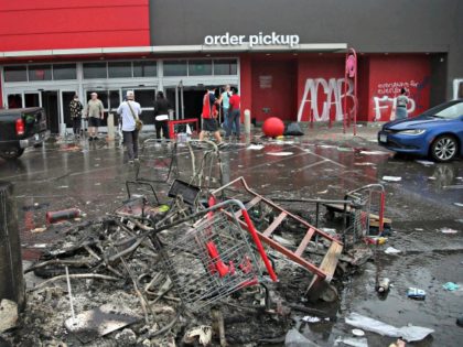 Debris and carts are strewn in the Target parking lot near the Minneapolis Police Third Precinct, Thursday, May 28, 2020, following a night of rioting and looting as protests continue over the arrest of George Floyd who died in police custody. Floyd died after being restrained by Minneapolis police officers …
