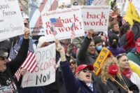 In this April 24, 2020 file photo protesters gather for a rally against Gov. Tony Evers' extended stay-at-home order due to COVID-19, at the Wisconsin State Capitol in Madison, Wis. The Wisconsin Supreme Court struck down Gov. Evers' coronavirus stay-at-home order Wednesday, May 13, 2020 ruling that his administration overstepped …
