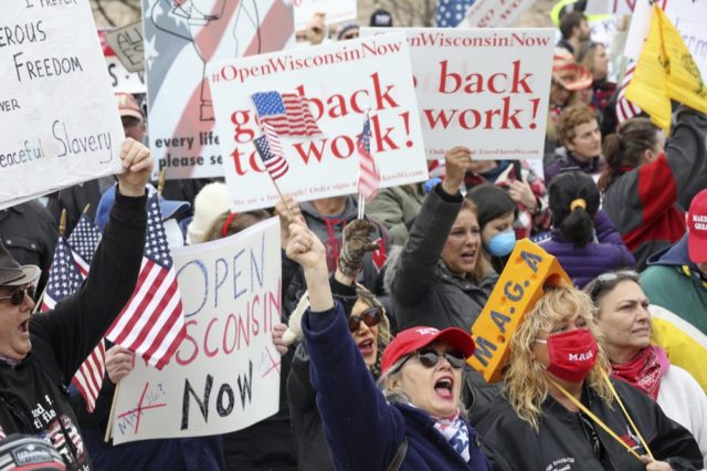 In this April 24, 2020 file photo protesters gather for a rally against Gov. Tony Evers' e