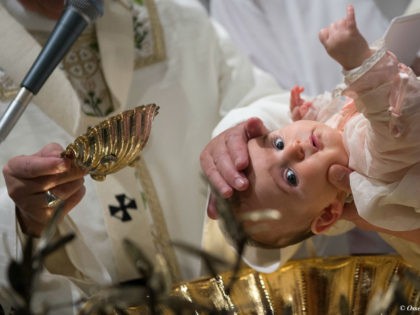 Pope Francis baptizes a baby at the Vatican, Sunday, Jan. 10, 2016. Pope Francis welcomed 13 boys and 13 girls into the Catholic Church on Sunday during the annual ceremony, held in the Sistine Chapel, that marks the day in the liturgical calendar when Jesus was baptized. (L'Osservatore Romano/Pool Photo …