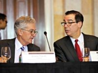 Treasury Secretary Steve Mnuchin, right, speaks with Federal Reserve Chairman Jerome Powell, at the start of a meeting of the Financial Stability Oversight Council, Tuesday, Oct. 16, 2018, at the Treasury Department in Washington. (AP Photo/Jacquelyn Martin)