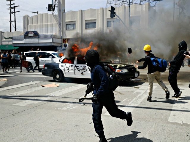 LOS ANGELES, CALIFORNIA - MAY 30: An LAPD vehicle burns after being set alight by protestors during demonstrations following the death of George Floyd on May 30, 2020 in Los Angeles, California. The vast majority of protestors demonstrated peacefully. Former Minneapolis police officer Derek Chauvin was taken into custody for …