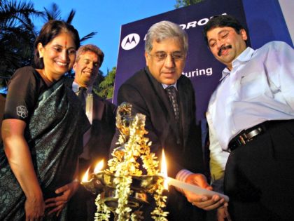 Chairman Motorola India Firdose Vandrevala, center, lights a lamp during a press conference in Madras, India, Wednesday, June 7, 2006. Motorola Inc. will invest US$100 million to build a handset and telecom equipment plant in India, the company said Wednesday, in a move aimed at countering rival Nokia Corp.'s dominance …