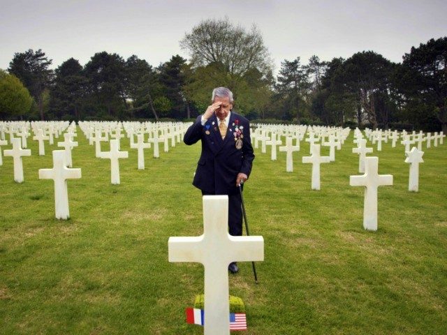 In this May 1, 2019 file photo, World War II and D-Day veteran Charles Norman Shay, from Indian Island, Maine, salutes the grave of fellow soldier Edward Morozewicz at the Normandy American Cemetery in Colleville-sur-Mer, Normandy, France. Instead of parades, remembrances, embraces and one last great hurrah for veteran soldiers …