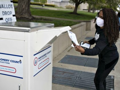A voter drops off her ballot at the Board of Elections in Dayton, Ohio on Wednesday. The state changed primary voting to a vote-by-mail system to reduce chances of the coronavirus spread. Photo: Megan Jelinger/AFP via Getty Images