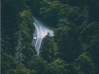 Aerial photograph of one car on a highway.