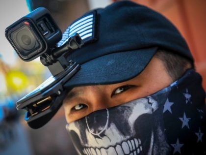 Eddie Song a Korean American entrepreneur, arrives at his motorcycle storage garage wearing a video camera clipped to his cap and a face mask due to COVID-19, Sunday April 19, 2020, in East Village neighborhood of New York. "I was assaulted a few months ago by someone who said that …