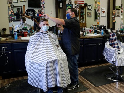 Eli Resendez, left, owner of the Barber Shop 32 in Westfield, Ind. and his brother Chuy Re
