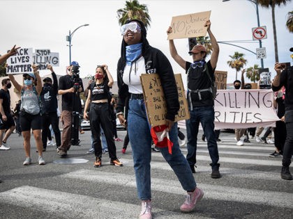 Protesters march in Beverly Hills, Calif., on Saturday, May 30, 2020, over the death of George Floyd, who died in police custody on Memorial Day in Minneapolis. (AP Photo/Christian Monterrosa)