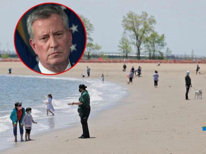 A security guards asks people to not swim while patrolling at Orchard Beach in the Bronx b