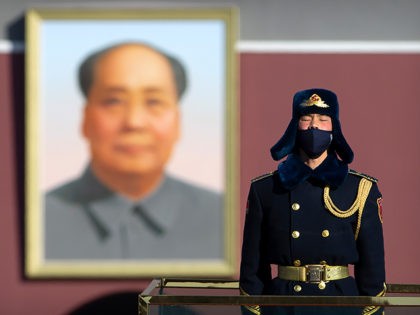 A member of a Chinese honor guard wears a face mask as he stands guard on Tiananmen Square
