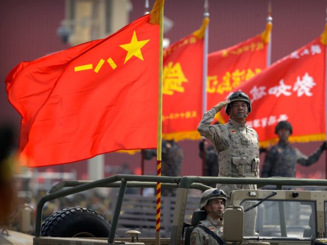 A Chinese military officer salutes during a parade to commemorate the 70th anniversary of the founding of Communist China in Beijing, Tuesday, Oct. 1, 2019. Trucks carrying weapons including a nuclear-armed missile designed to evade U.S. defenses rumbled through Beijing as the Communist Party celebrated its 70th anniversary in power …