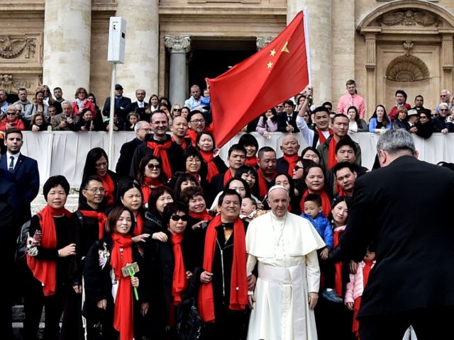 Pope Francis poses for a picture with faithful from China as he arrives for his weekly general audience on April 18, 2018, on St. Peter's square in the Vatican. / AFP PHOTO / TIZIANA FABI (Photo credit should read TIZIANA FABI/AFP via Getty Images)