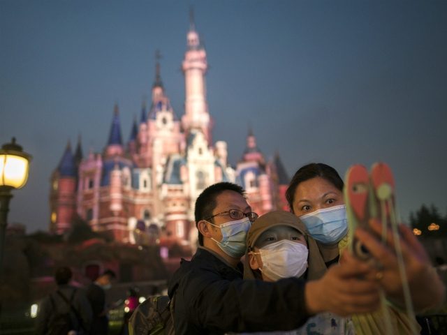 SHANGHAI, CHINA - MAY 11: Tourists visit Shanghai Disneyland after its reopening on May 11, 2020 in Shanghai, China. Shanghai Disneyland has reopened its gates following months of shutdown, offering a potential model for other mass entertainment venues around the world to open for business during the pandemic. (Photo by …