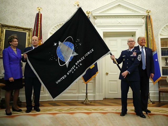 President Donald Trump stands as Chief of Space Operations at US Space Force Gen. John Raymond, second from left, and Chief Master Sgt. Roger Towberman, second from right, hold the United States Space Force flagÂ as it is presented in the Oval Office of the White House, Friday, May 15, 2020, in Washington. Secretary of the Air Force Barbara Barrett stands far left. (AP Photo/Alex Brandon)