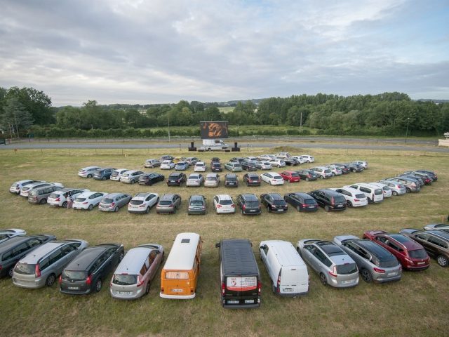 Cinema-goers watch a movie from their cars at a drive-in theater in Les Herbiers, western