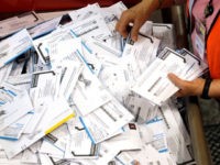 In this May 17, 2016, file photo, ballots are prepared for counting at Multnomah County election headquarters in Portland, Ore. The coronavirus has knocked presidential primaries back several weeks as officials worry about voters crowding into polling places. If the disease remains a hazard in November, Democrats say there's only …
