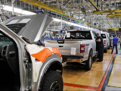 FILE - In this Sept. 27, 2018, file photo a United Auto Workers assemblymen work on a 2018 Ford F-150 trucks being assembled at the Ford Rouge assembly plant in Dearborn, Mich. The United Auto Workers union wants Detroit's three automakers to shut down their factories for two weeks to …