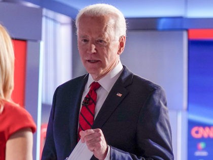 Former Vice President Joe Biden, center, stops to talk with CNN anchor Dana Bash, left, as