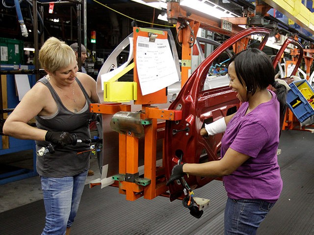 FILE - In this file photo taken June 15, 2010, Patti Burkel, left, and Tasha Livingston install wiring in a car door at General Motors' Lordstown Assembly plant in Lordstown, Ohio. An industry trade group said Wednesday. Sept. 1, 2010, manufacturing companies grew faster in August as the industrial sector …