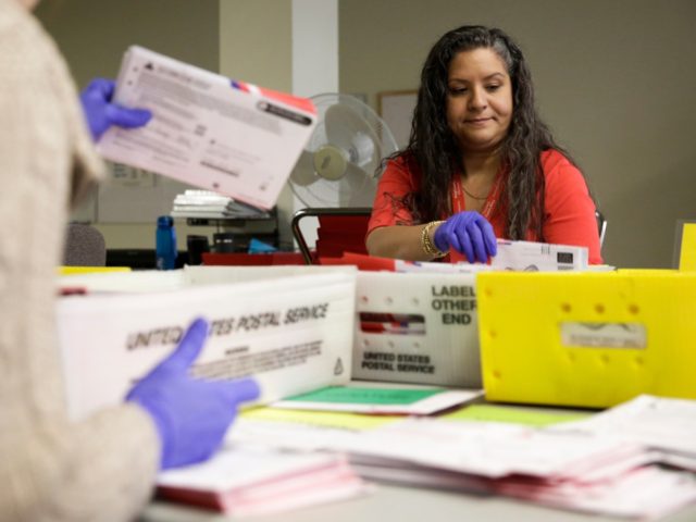 Ballot Processing Manager Jerelyn Hampton sorts vote-by-mail ballots by party for the pres