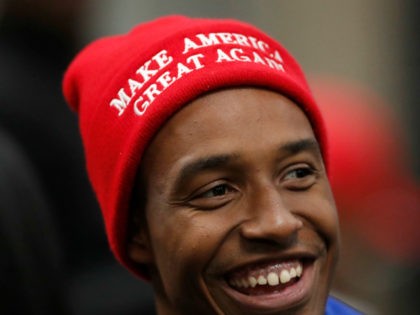 A supporter of President Donald Trump waits for Trump to arrive for a Black Voices for Trump rally Friday, Nov. 8, 2019, in Atlanta. (AP Photo/John Bazemore)