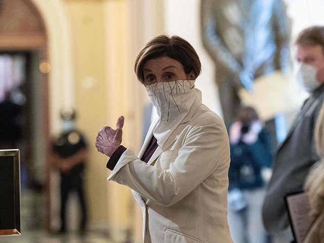TOPSHOT - US House Speaker Nancy Pelosi walks to the chamber of the US House of Representatives start of a vote on the additional 484 billion dollar relief package amid the coronavirus pandemic at the US Capitol in Washington, DC, on April 23, 2020. (Photo by NICHOLAS KAMM / AFP) …