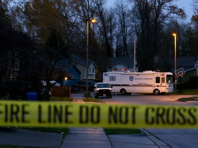 A Tacoma Police mobile command vehicle remains parked behind yellow tape, Thursday, Dec. 1