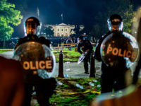 TOPSHOT - Demonstrators confront secret service police and Park police officers outside of the White House on May 30, 2020 in Washington DC, during a protest over the death of George Floyd, an unarmed black man, who died after a Minneapolis police officer kneeled on his neck for several minutes. …