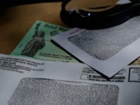 President Donald Trump's name is seen on a stimulus check issued by the IRS to help combat the adverse economic effects of the COVID-19 outbreak, in San Antonio, Thursday, April 23, 2020. According to the Treasury Department, it marks the first time a president's name has appeared on any IRS …