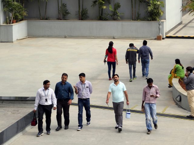FILE- In this Jan. 18, 2016 file photo, Wipro Ltd. employees walk inside the company's compound during a break at their headquarters in Bangalore, India. The shares of top Indian IT companies are falling in response to news of proposed U.S. legislation that would require salaries for H-1B visa holders …