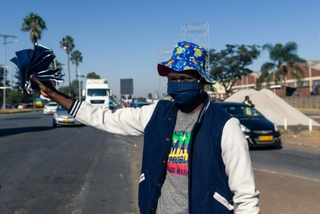 Aaron Makaya sells re-useable cloth face masks on the streets of Harare © AFP Jekesai NJIKIZANA